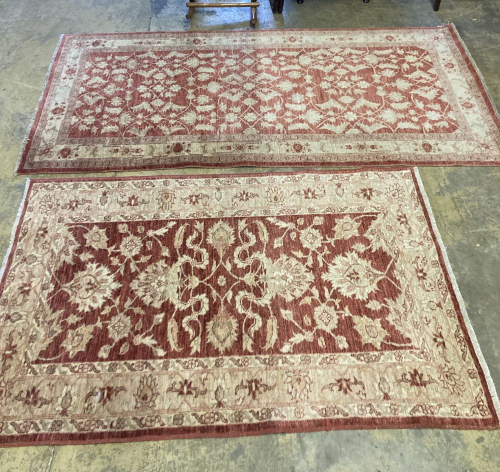 A near pair of Ziegler style red ground rugs, larger 255 x 125cm